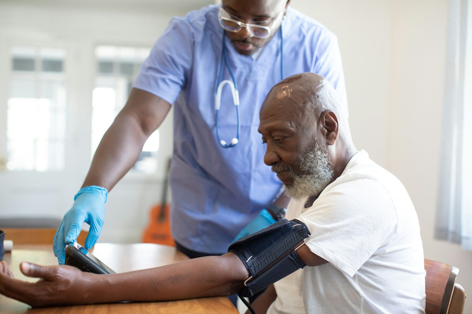 Vincent Owiyo, RN checking blood pressure
